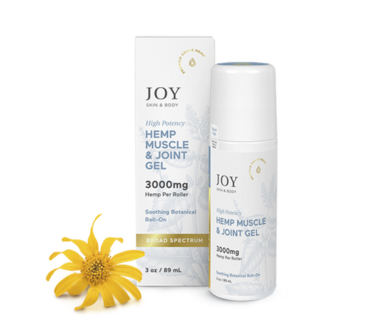 White roll-on bottle and box of Joy Hemp Muscle & Joint Gel 3000mg next to a yellow flower.